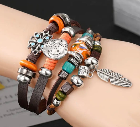 layered leather bracelet with feather and sun moon charms