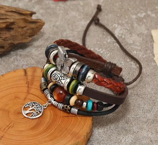 layered leather bracelet with butterfly and tree of life charms
