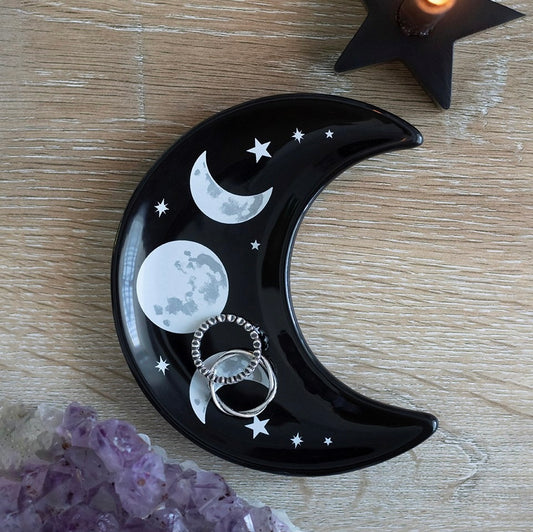 black crescent moon shaped trinket dish with moon phases and stars design