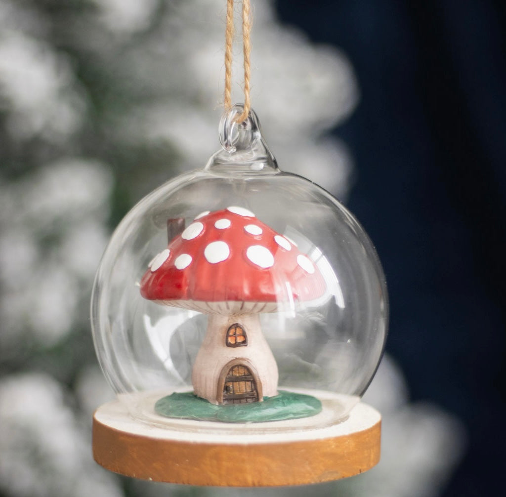 glass dome ornament with mushroom house inside