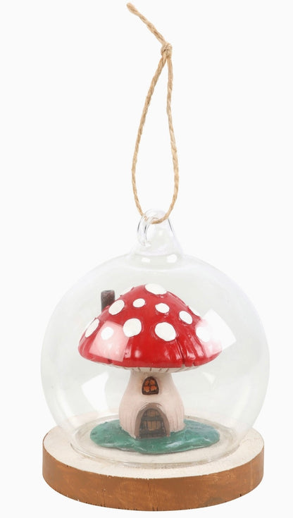 glass dome ornament with mushroom house inside