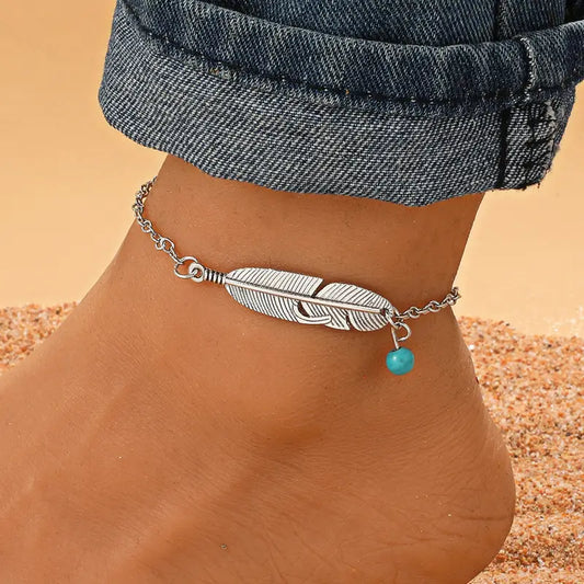 feather anklet on ankle