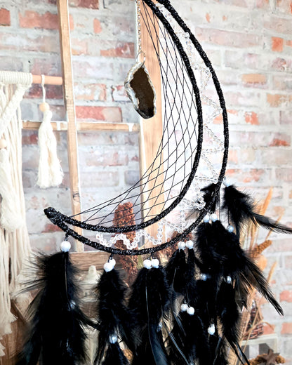 crescent moon dream catcher with black feathers and hanging geode boho hippie home décor close up