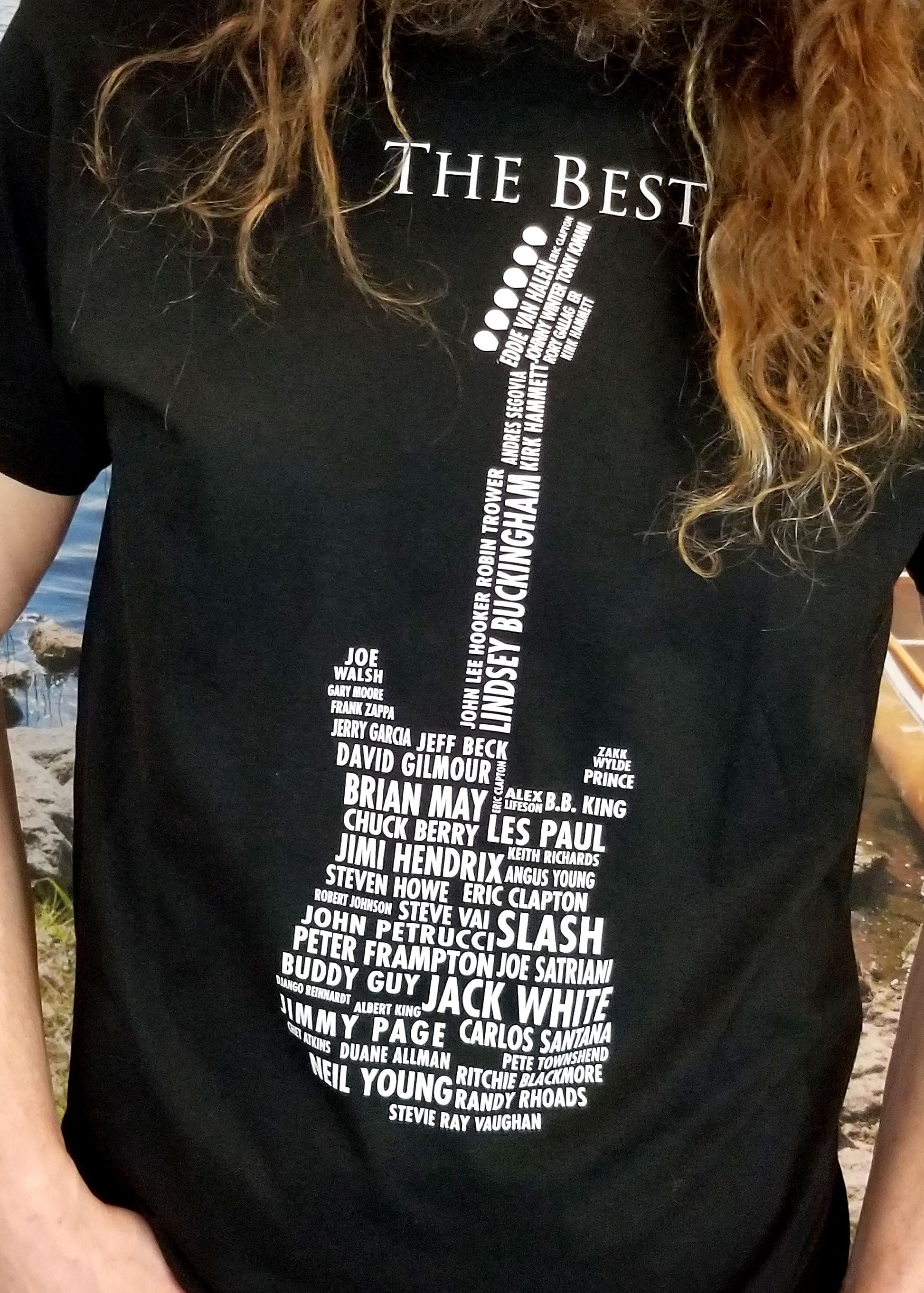 close up black guitar t shirt with names of guitarists on front