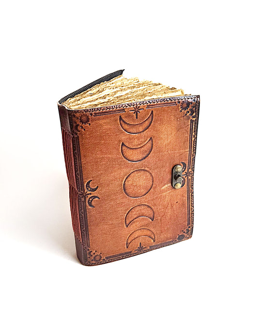 leather journal with embossed moon phase design antique buckle closure and deckle edge vintage look paper top front