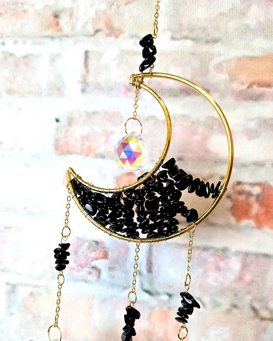 crescent moon crystal suncatcher with obsidian stones for boho hippie home décor close up