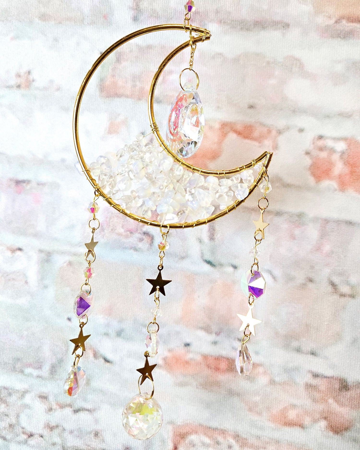 close up of opal crescent moon crystal suncatcher with stars for boho hippie home décor