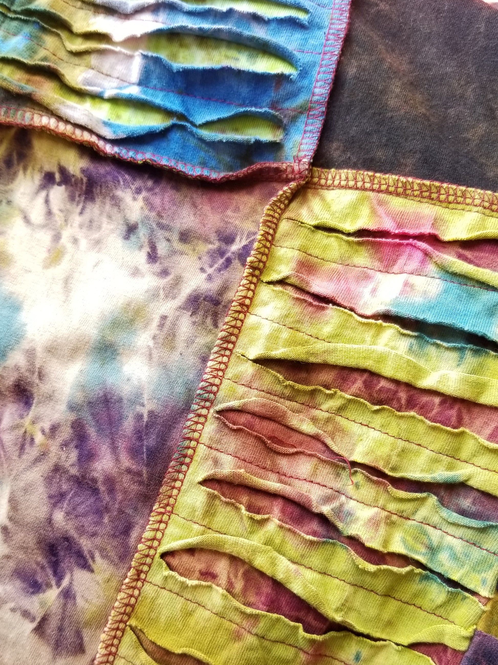 close up of razor cut tie dye patchwork overalls at the boho hippie hut midland michigan