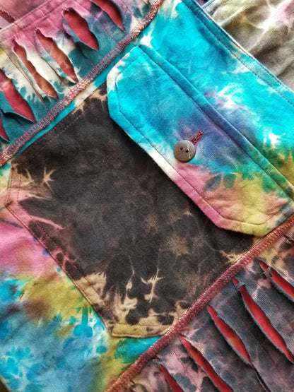 close up front pocket with button closure razor cut tie dye patchwork overalls at the boho hippie hut midland michigan