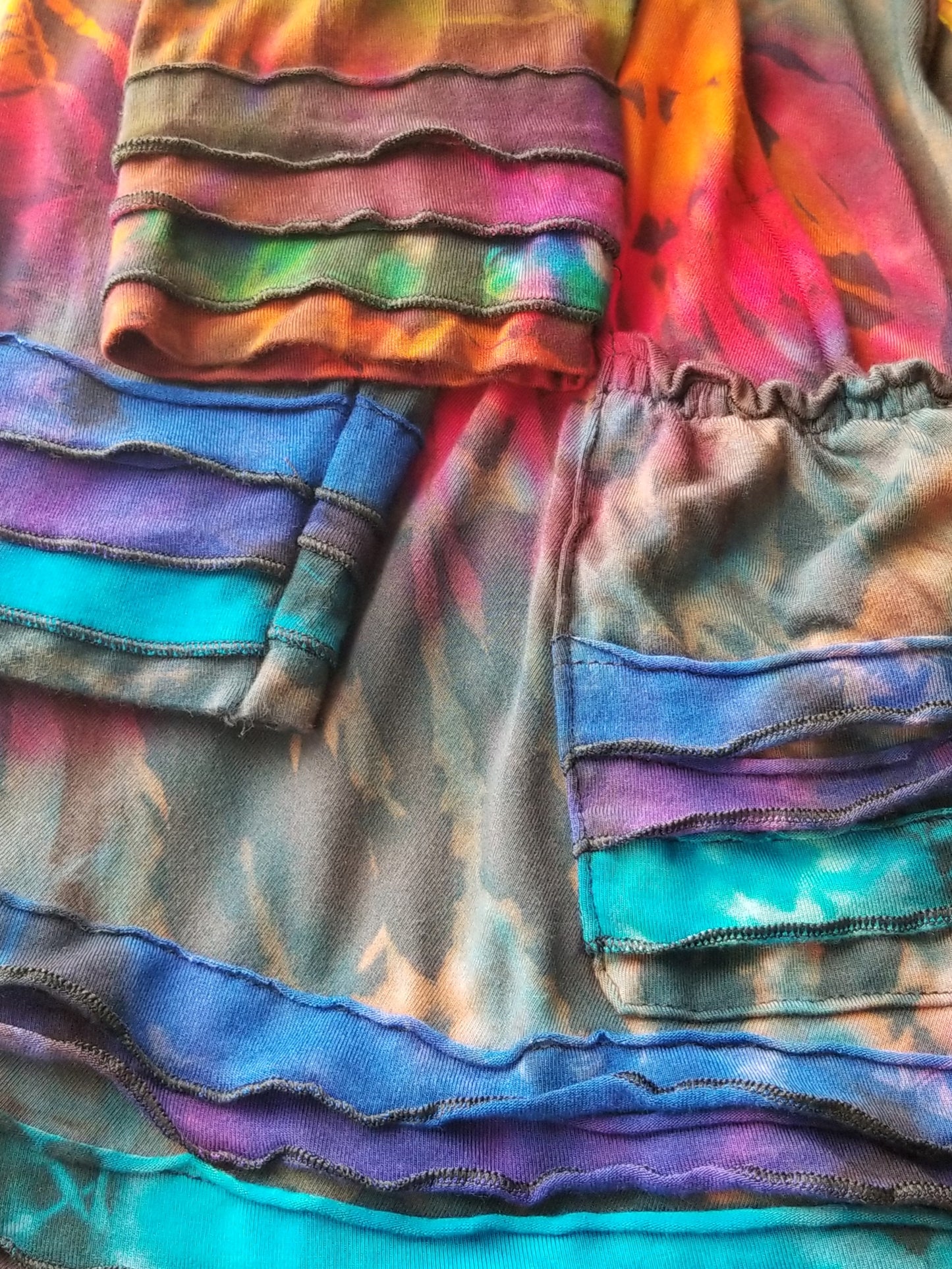 close up of sleeves and pocket on tie dye hoodie dress at the boho hippie hut midland michigan