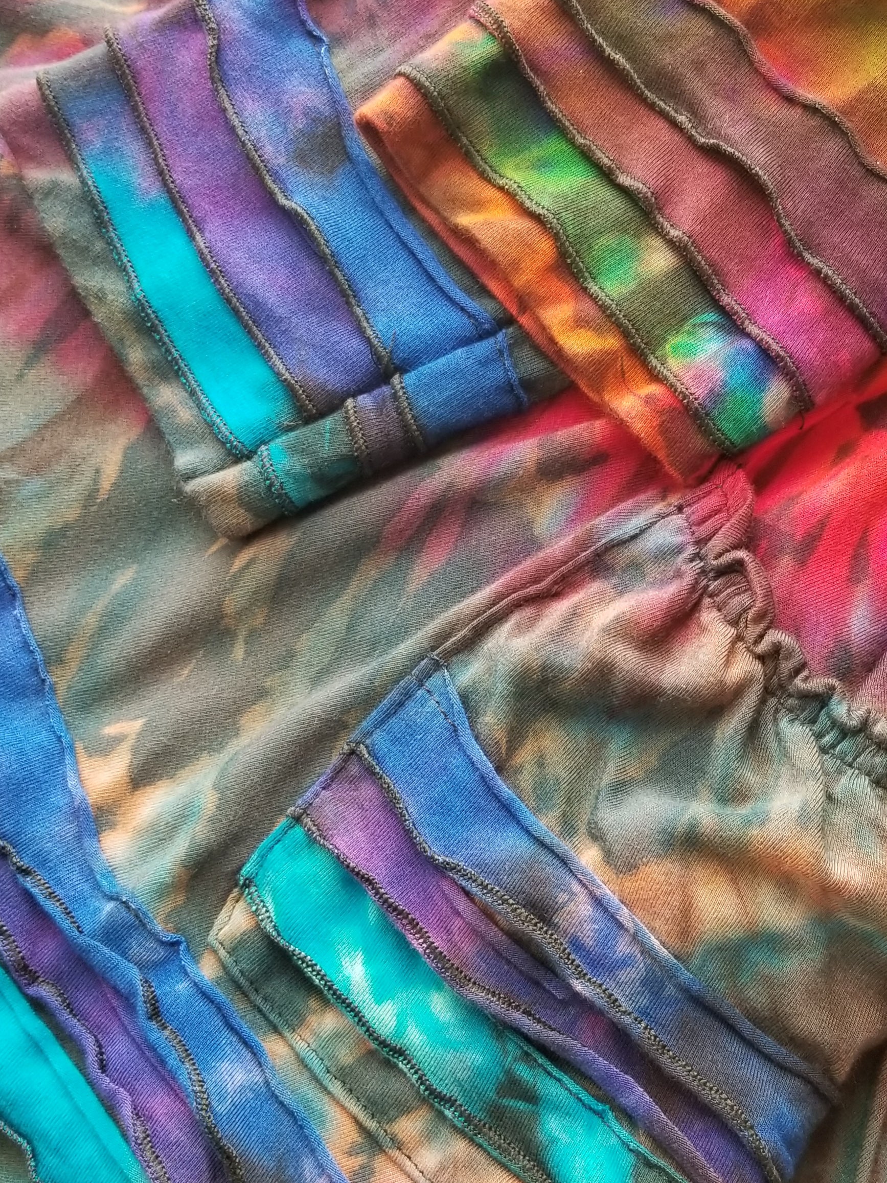 close up of sleeves and pocket on tie dye hoodie dress at the boho hippie hut midland michigan