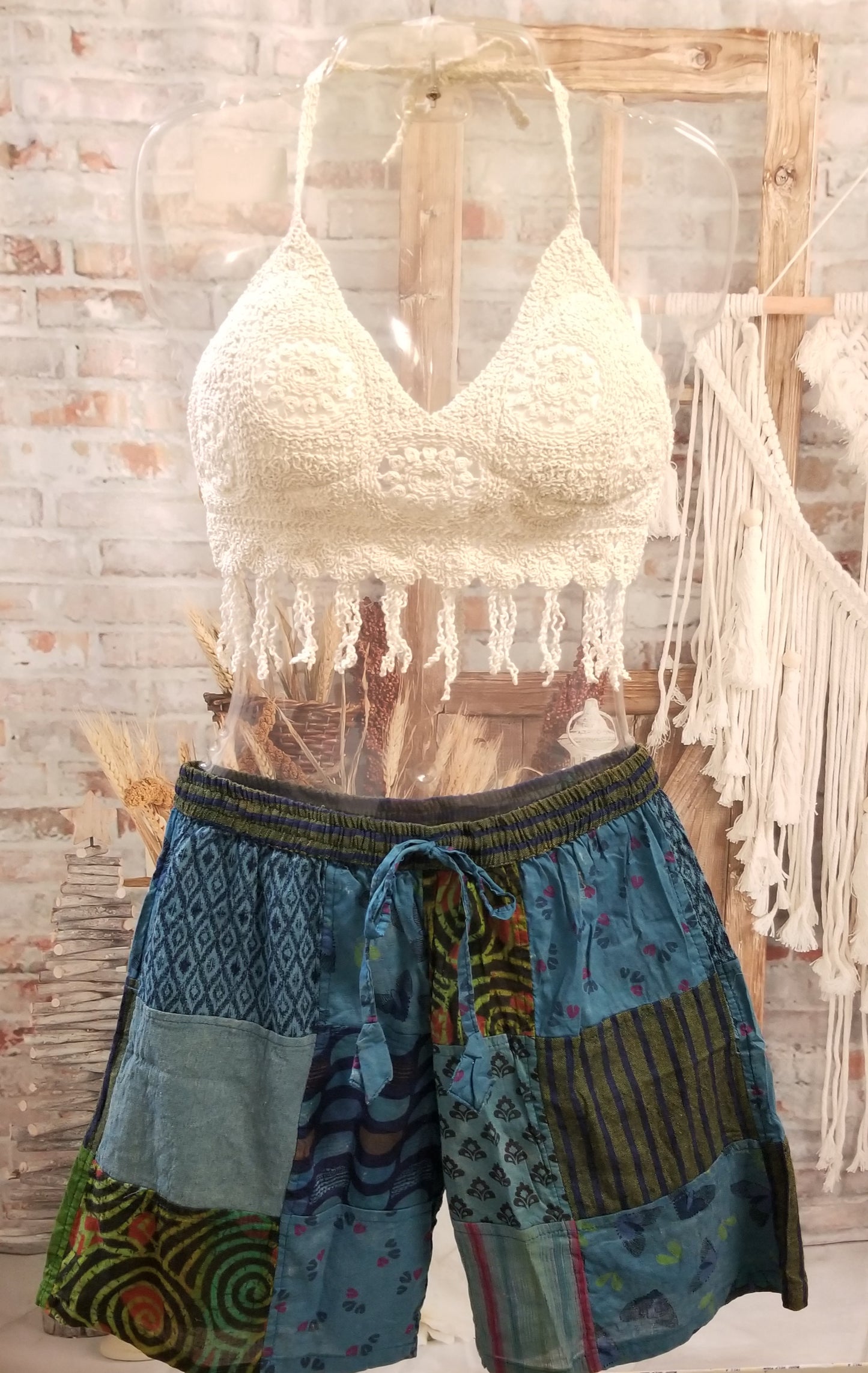 short crochet halter top with fringe shown with blue patchwork shorts