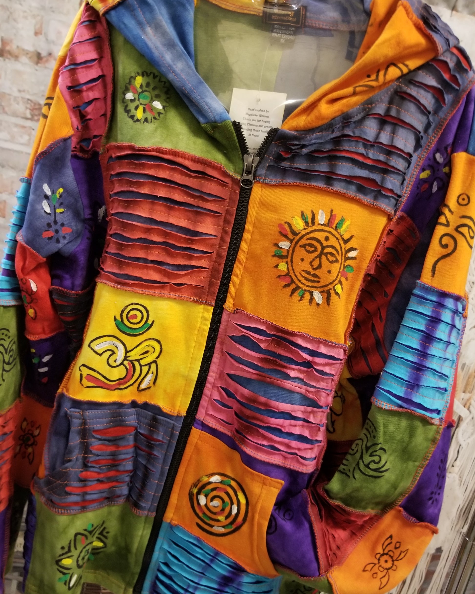 razor cut hippie jacket in multi color with sun and om designs front