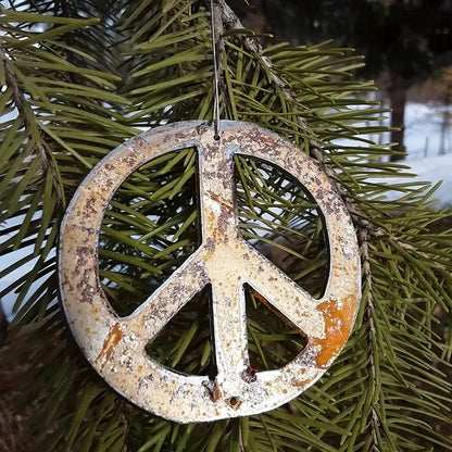 rustic metal peace sign ornament on tree