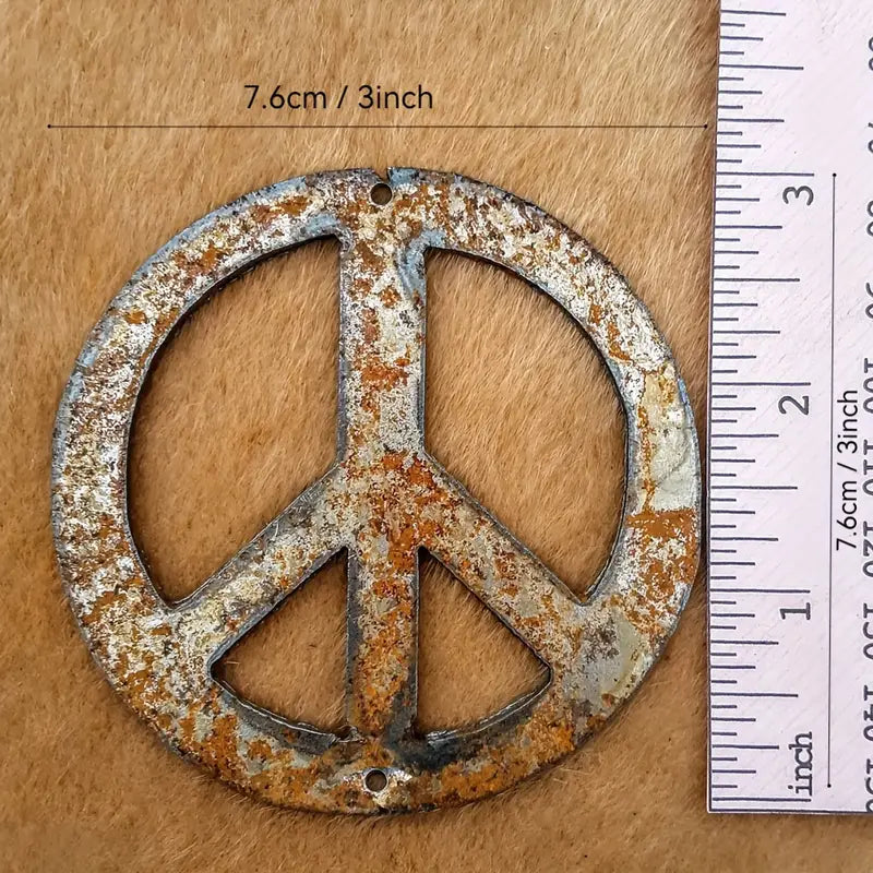 3 inch rustic metal peace sign ornament shown with ruler 