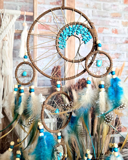 teal and brown tree of life dream catcher with feathers close up boho hippie home decor