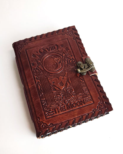 leather journal with embossed the moon tarot card design antique buckle closure and leather stitched edges front