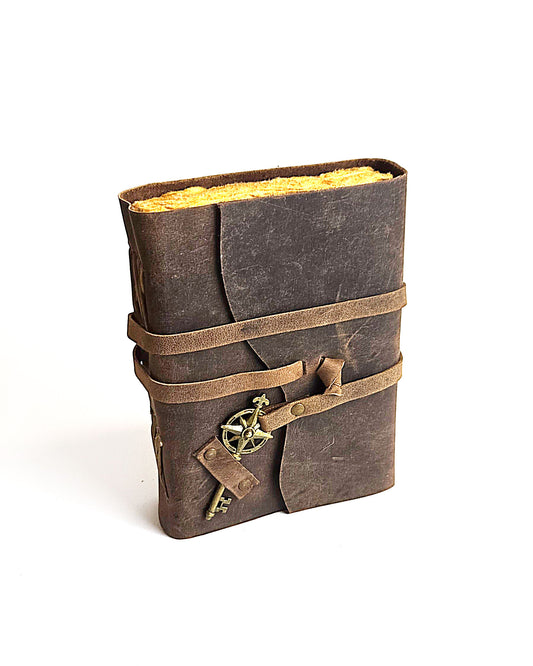 leather journal with a leather strap with decorative antique key closure and deckle edge vintage look paper  front view