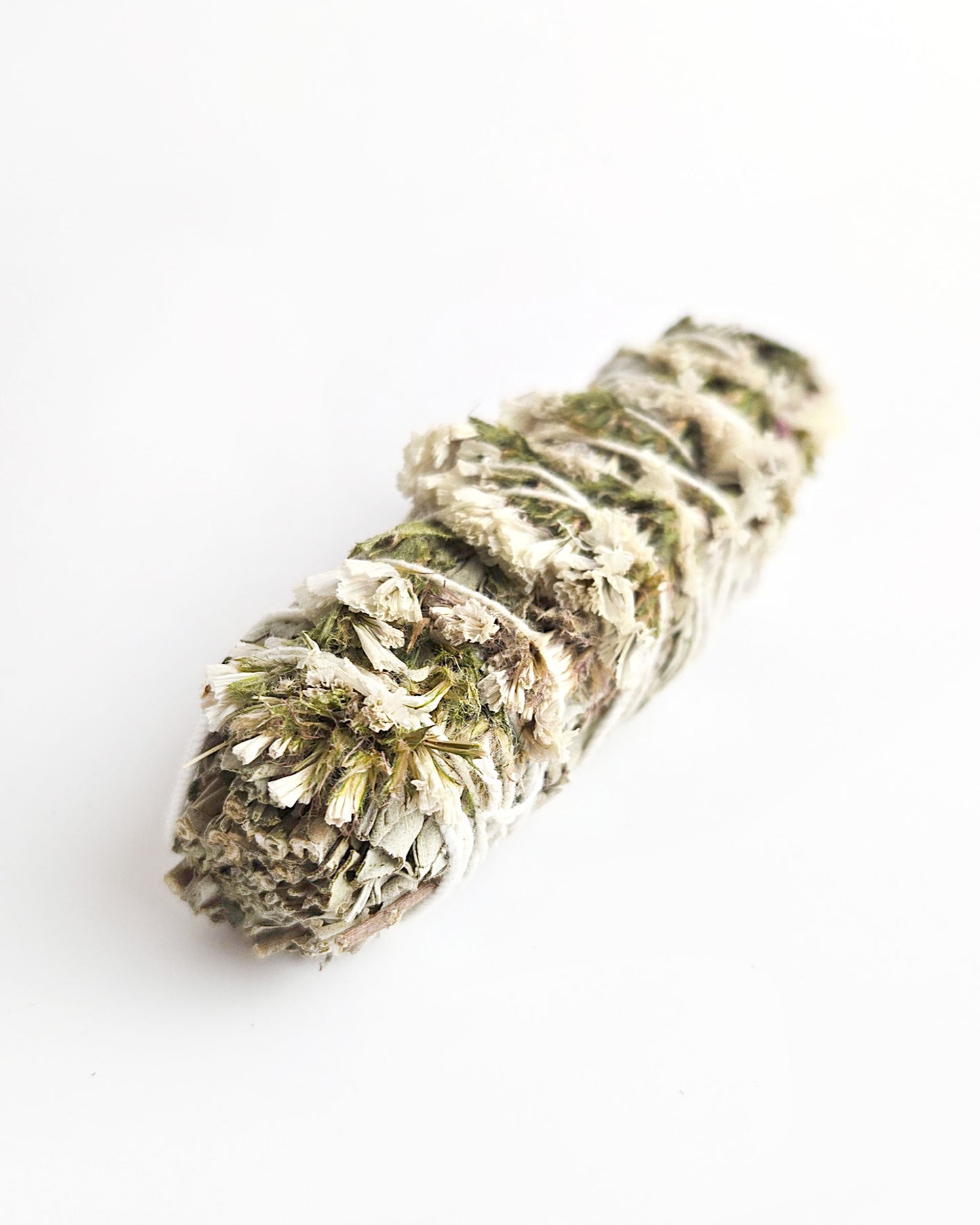 sage stick for smudging with white sinuata flowers